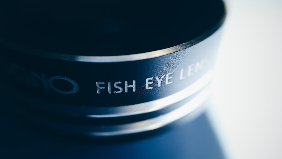 Professional eyelash technician performing lash extension service in modern beauty studio